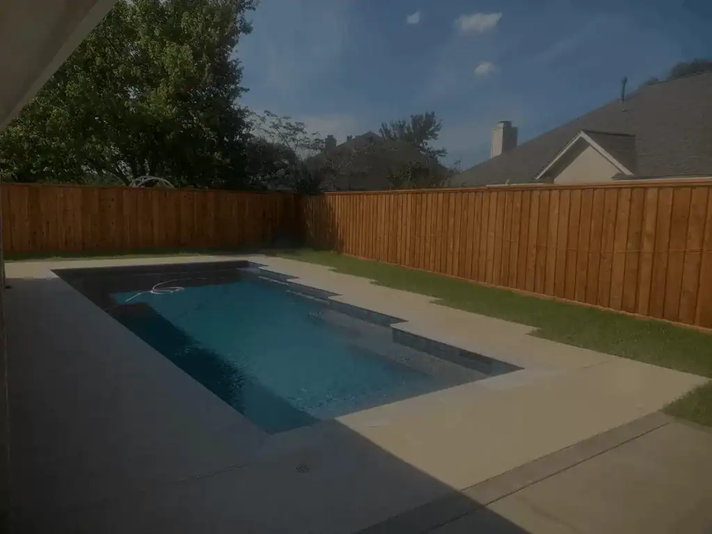 Cedar privacy fence around a backyard pool, installed by Astro Outdoor Designs