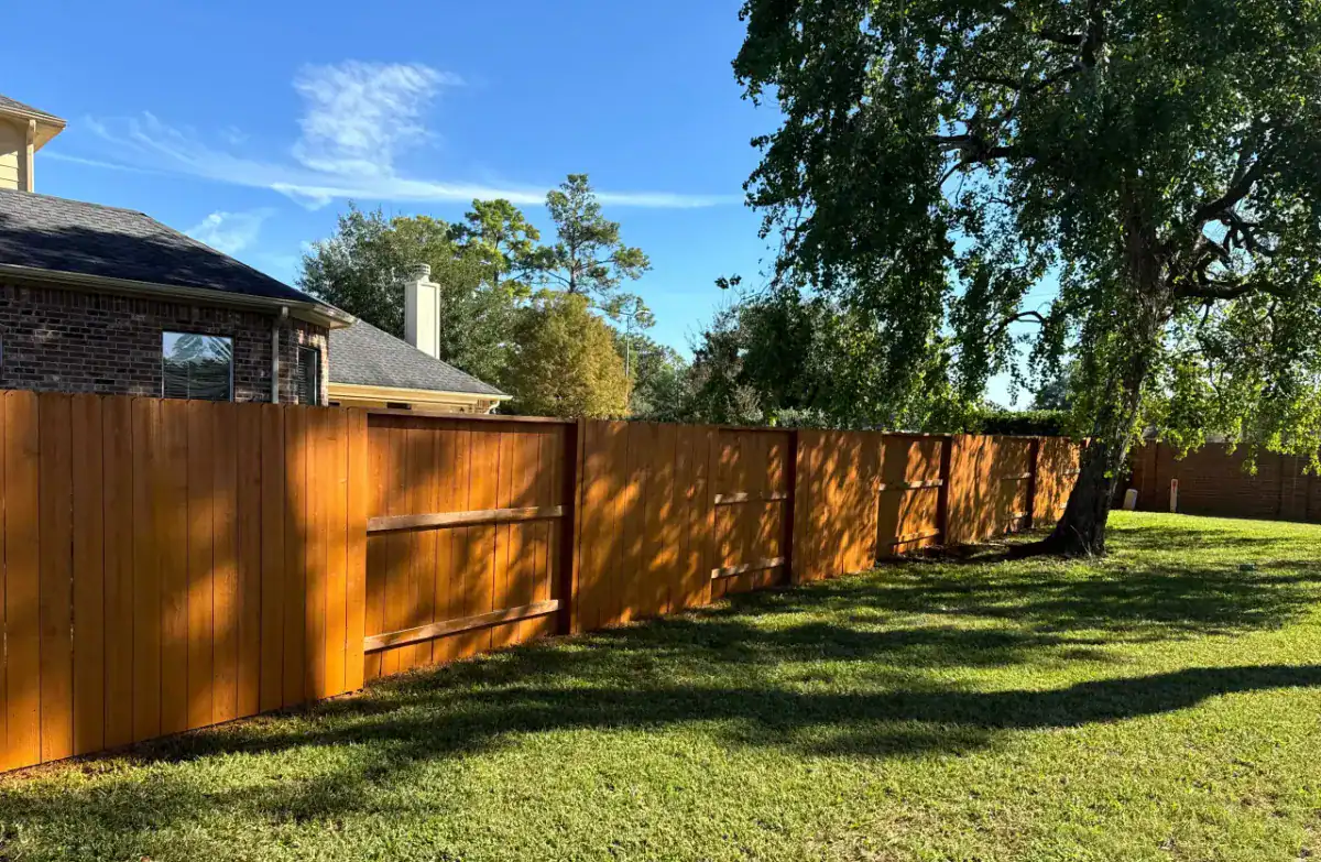 Stained cedar privacy fence installed by Astro Outdoor Designs in Kingwood